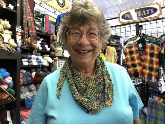 Customer sporting g her scarf knit from Nancy's hand-painted yarn.