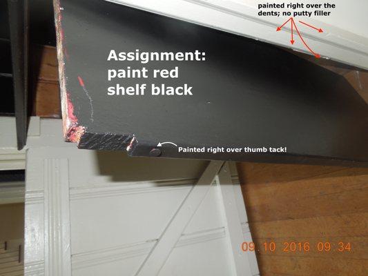 The red shelf was supposed to be painted black.  You see the result.  Note that they painted right over a thumb tack instead of removing it.