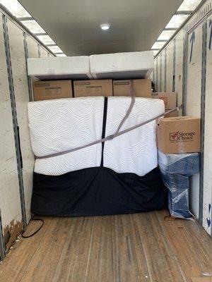 Part of the process of playing Tetris in the box truck is using items such as a bed to stop the boxes from moving!