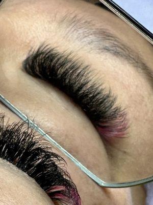 Volume eyelash extensions with a peek a boo of pink