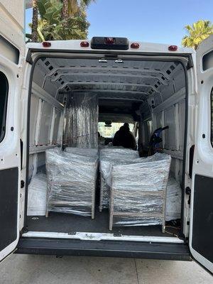 Couch and multiple chairs ready to be delivered to a new home