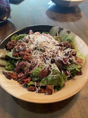 Spinach salad with bacon crumbles, fresh Parmesan cheese and balsamic vinaigrette