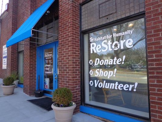 Look for the big brick building with the bright blue trim!