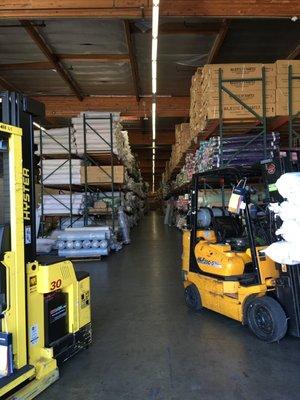 Top Fabric warehouse with forklifts.