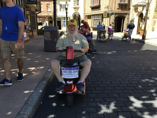 Happy to be at Epcot Food & Wine Festival, and happy with his scooter!