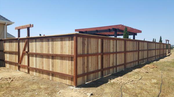 Tri-Rail Cedar Fence with Redwood Top Cap.