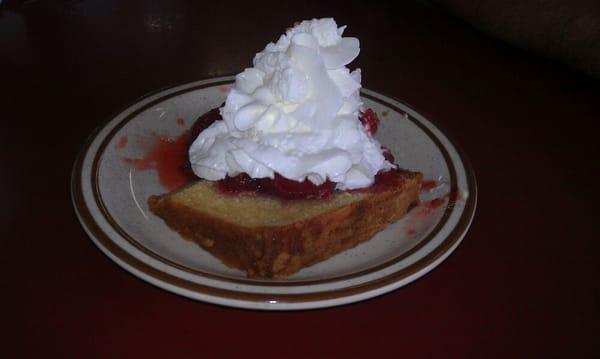 Homemade pound cake and strawberries with whipped cream.