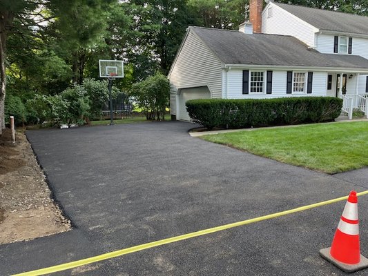 New driveway!  This was a complete dig out of large roots and stumps. The front walkway was also leveled and poly sealed.