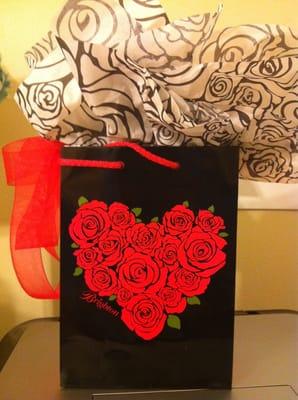 Gift bag with bow and tissue paper that comes with purchase