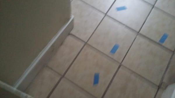 Tile still have tape in the pieces that are cracked. Tape was placed there from contractors