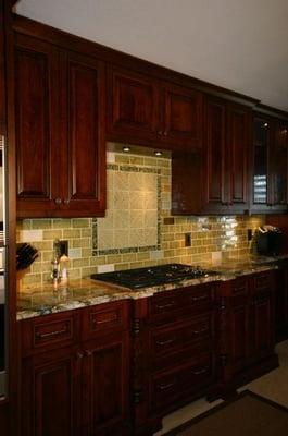 Granite countertops with hand made glass tile back splash