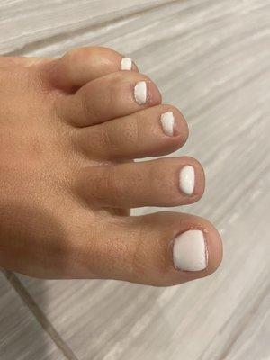 A terribly painted pedicure with a way too short big toe nail