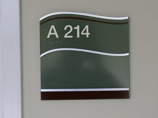 Acrylic ADA signage with aluminum accents and window insert