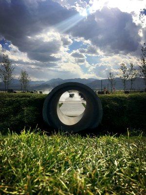 View of our Fog Water Feature through a play Tunnel at Lake Avenue South