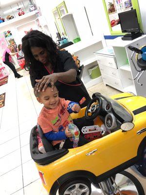 Ms. Cynthia giving our 2yr old a haircut. She was fast, professional & very personable!! He loved her!!