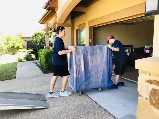 Professionally wrapped furniture being carefully moved by the Fietz brothers!