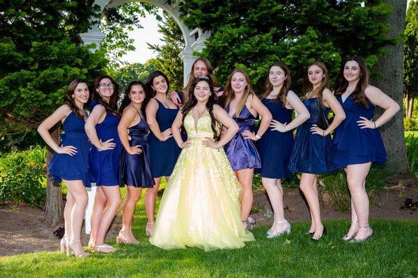 Quinceañera Photoshoot.  Birthday girl wearing a yellow dress and her girl friends are wearing blue dresess.