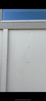 Nails coming out of the wall outside