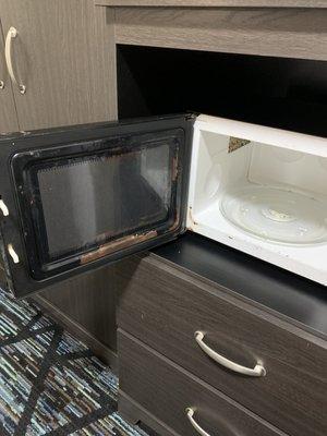 Dirty microwave; at first we thought it was rust but it was simply cooked on goop.