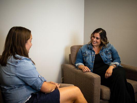 Kristy and Amanda connect at a team meeting