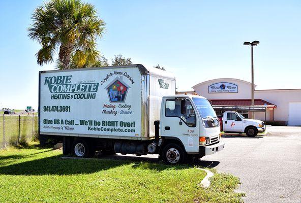 Two of our service vehicles parked in front of our office building