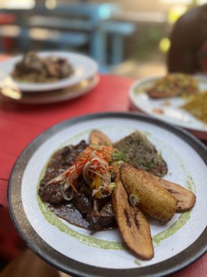 Oxtails with coconut rice and peas and platanos