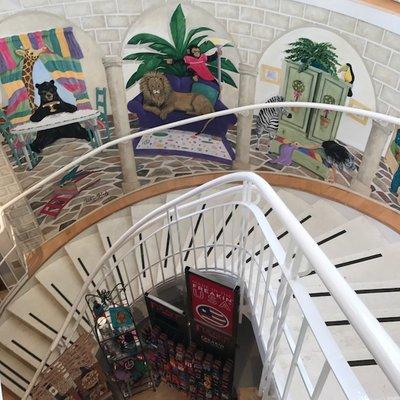 Our spiral staircase takes you downstairs to our general gift area, and features a colorful mural.