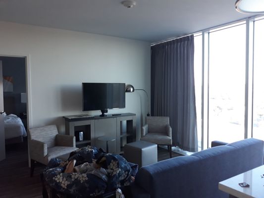 Sitting area of suite facing TV and 2nd bedroom