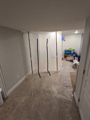 Water damage containment wall and carpet shield on the carpet