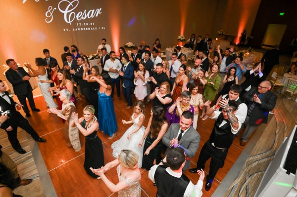 Providing DJ services with dance floor full, also the up lighting and monogram lighting.