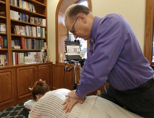 Dr. Joe adjusting a patient.