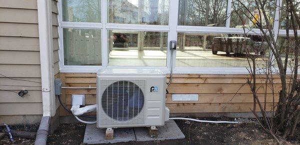 Outdoor condenser for installation in a sun room.