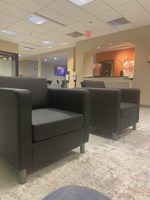 Waiting area of Office Evolution.  The orange wall is the location of the reception desk.