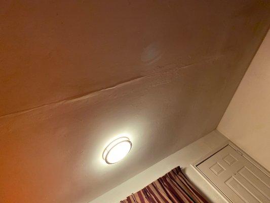 Ceiling falling apart over the bed