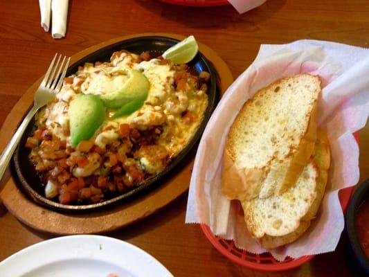 Camarones Jarochos. Parrillada with small sweet shrimp, tomato, onion, bacon and muenster cheese. French bread side. Incredible!