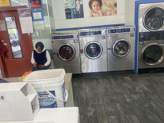 There's the woman sitting next to my two washers in operation. She put her head down as I backed away to take the photo.