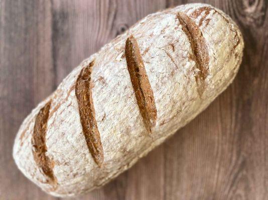 Rustic Multigrain Bread - one of our most popular! Available to take home as a half or whole loaf.