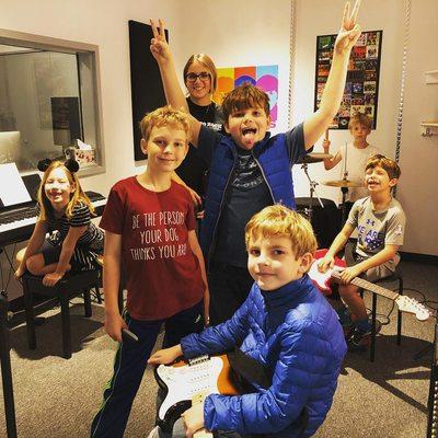 Rock band campers practicing their songs in the studio