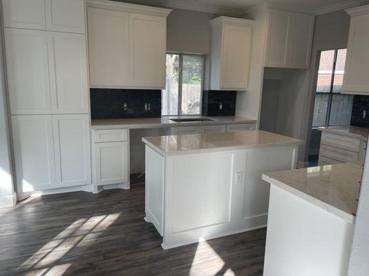 Water damage repairs on a house in Cypress, TX custom job built cabinets with quartz countertops.