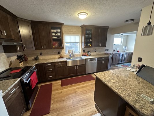 AFTER New floor, new cabs, new lighting, wall gone, extended countertops into adjoining room.