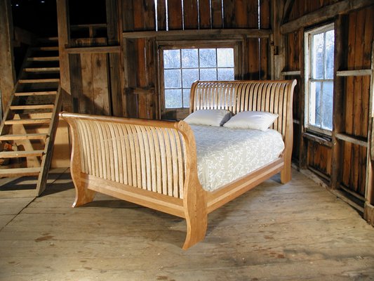 Sleigh bed in red birch and bird's-eye maple