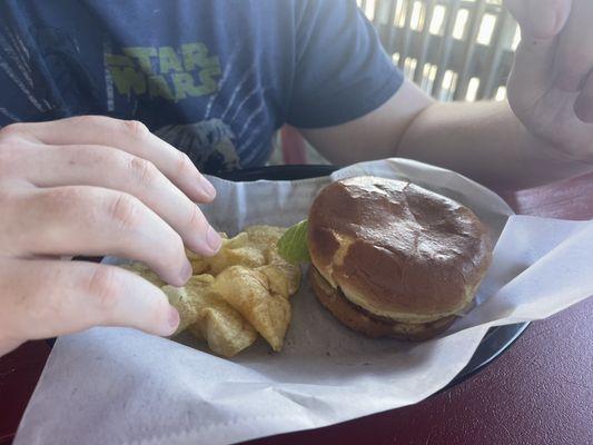 Grilled chicken sandwich with chips and a pickle