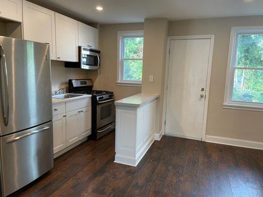 Kitchen installation with Luxury Vinyl Plank flooring and Stainless Steel appliances