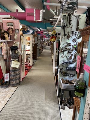 One of the many aisles showing a few of the booths, each one with it's own unique style and theme.