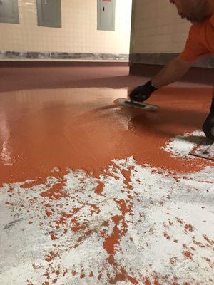 Troweling down urethane cement on a commercial kitchen floor