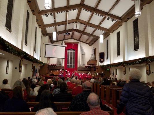 The congregation slowly took their seats as well as the choir.