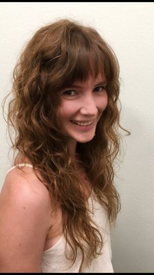 Natural wavy hair with lots of layers and bangs. Low maintenance and so fun!