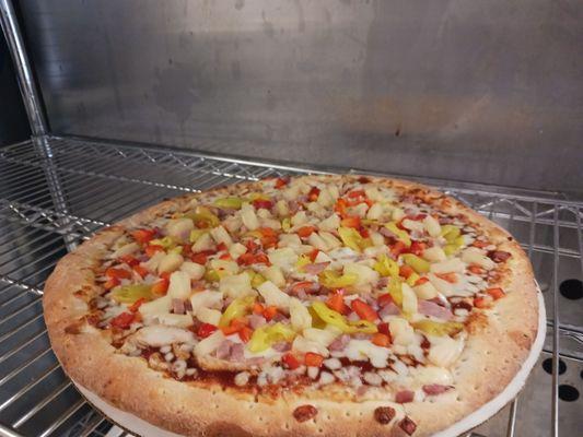 Sweet Chili BBQ Sauce, Chicken, Ham, Banana Pepper, Pineapple, and Red Pepper make up our Island Luau Pizza