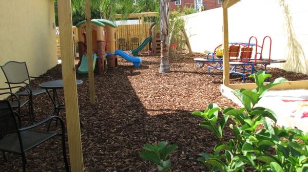 Just part of the beautiful outside patio area. LARGE, custom sandbox, slides, swings and a cement area to ride bikes, run, play basketball..