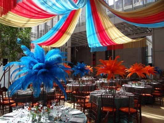 A Cirque event at the Morgan Library & Museum with Feather Centerpieces under a Chiffon Tent